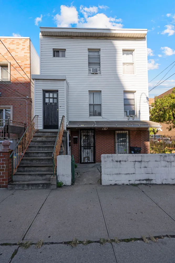 a view of a house with a stairs and a yard