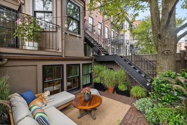a backyard of a house with outdoor seating