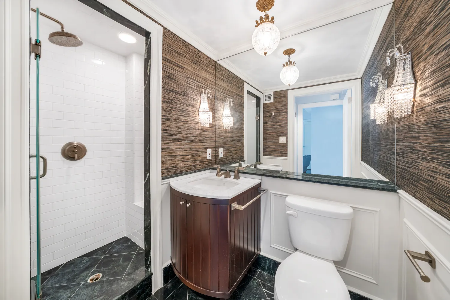 a bathroom with a toilet sink and mirror