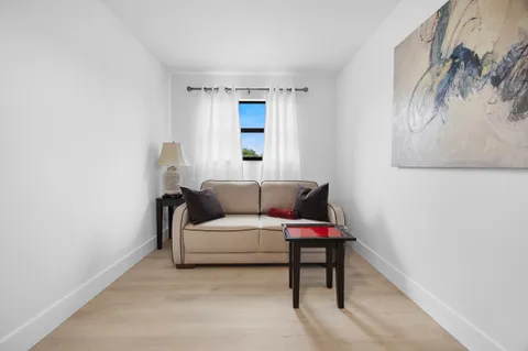 a bedroom with a large bed and a flat tv screen on dresser