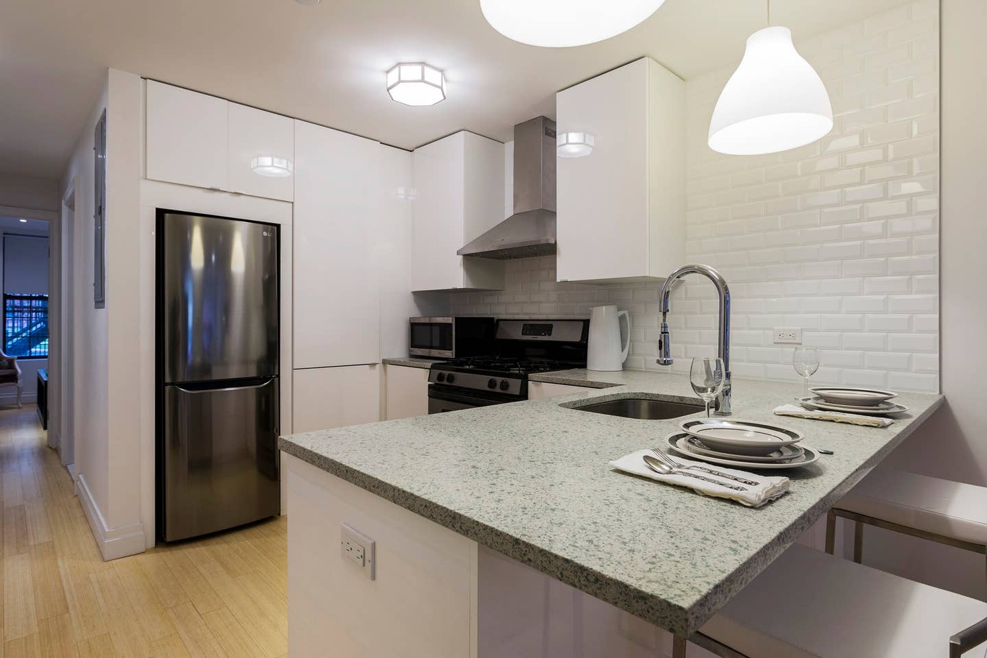 13 West 127th Street, Unit 1 Manhattan, NY 10027 - Photo 3 of 8 a kitchen with sink a refrigerator and chairs