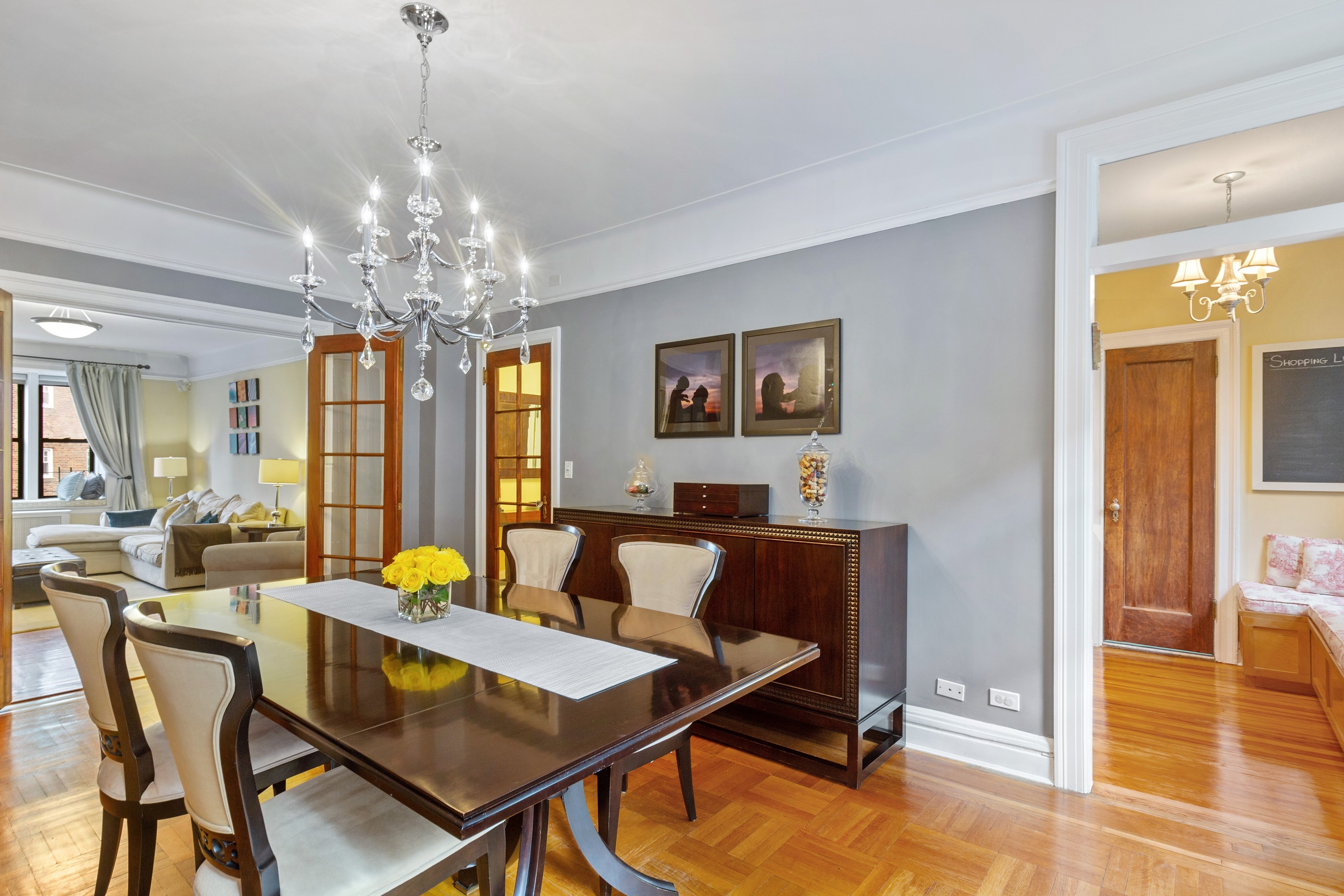 125 Cabrini Boulevard, Unit A52 Manhattan, NY 10033 - Photo 5 of 20 a view of a dining room with furniture a chandelier and wooden floor