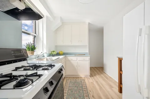 a kitchen with a stove and a white refrigerator