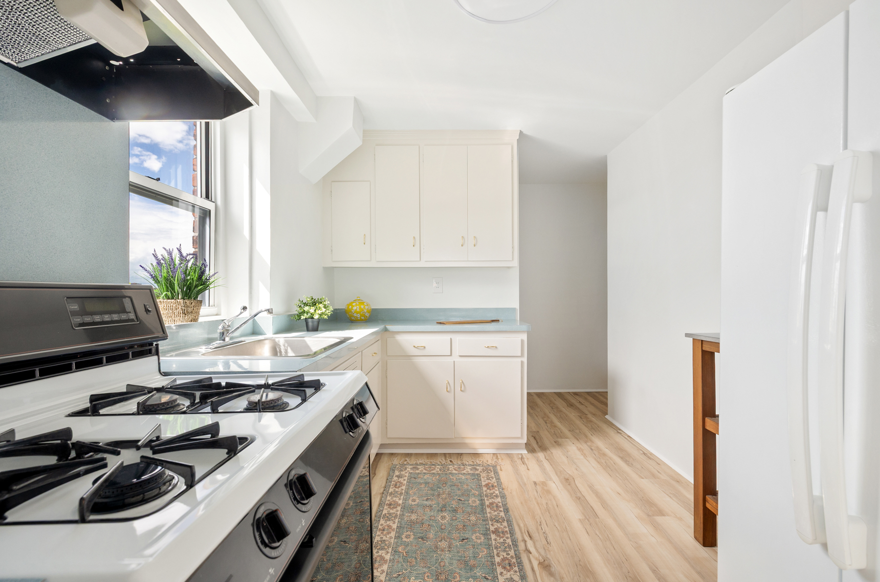 35-50 85th Street, Unit 9E Queens, NY 11372 - Photo 7 of 13 a kitchen with a stove and a white refrigerator