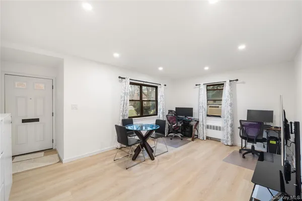 a view of a workspace with furniture and a window
