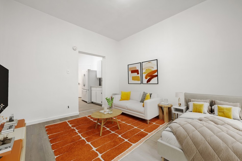 312 West 49th Street, Unit 1RW Manhattan, NY 10019 - Photo 5 of 12 a bedroom with two beds and a flat screen tv