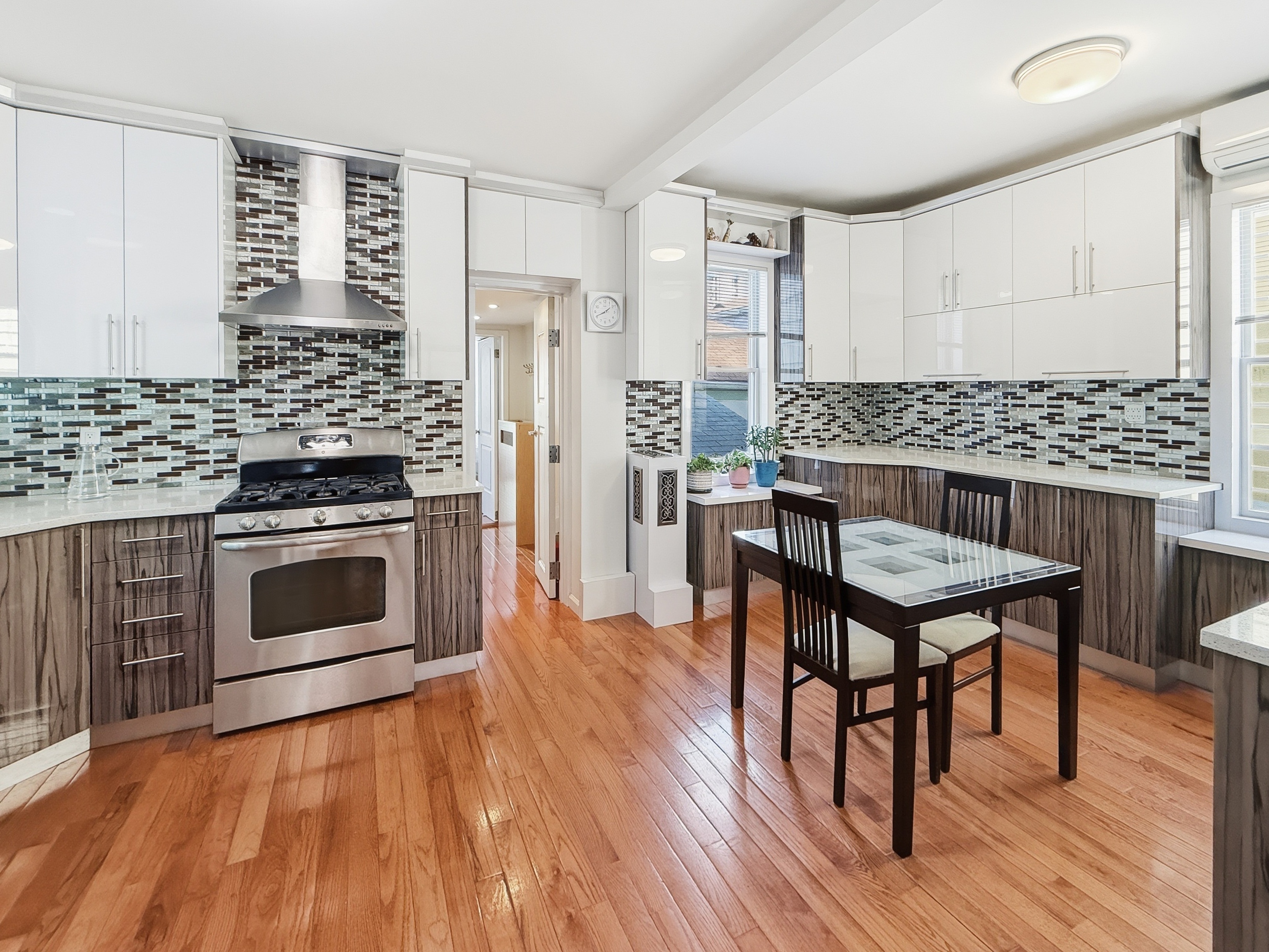 3735 Oceanic Avenue Brooklyn, NY 11224 - Photo 9 of 26 a kitchen with a stove a sink and wooden floor