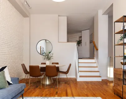 a view of a dining room with furniture and wooden floor