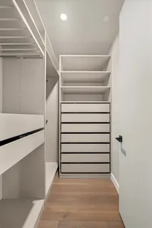 a view of walk in closet with empty racks