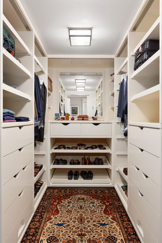 a view of walk in closet with clothes and shoes