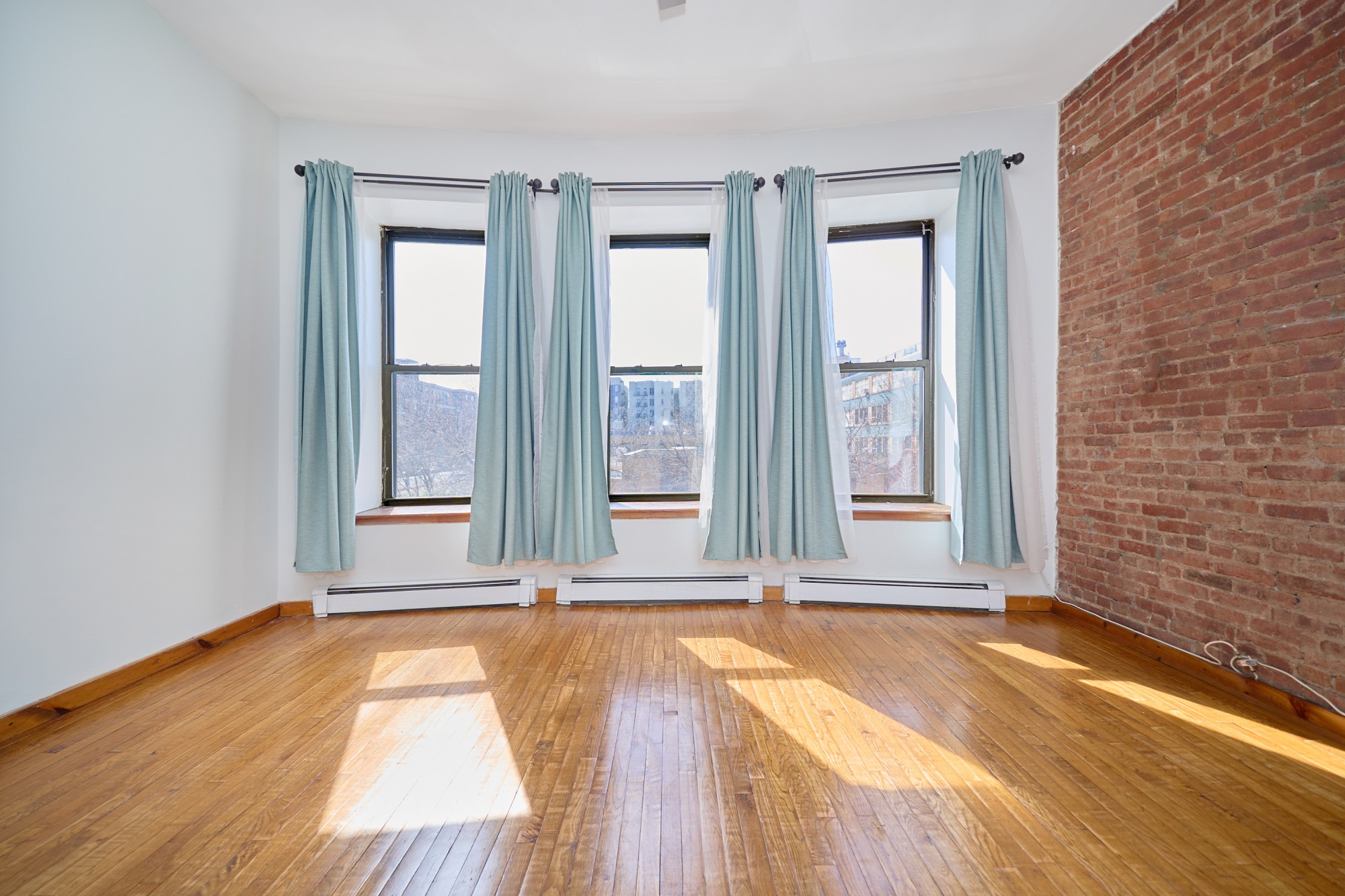 357 West 120th Street, Unit 2F Manhattan, NY 10027 - Photo 1 of 8 wooden floor and windows in a room