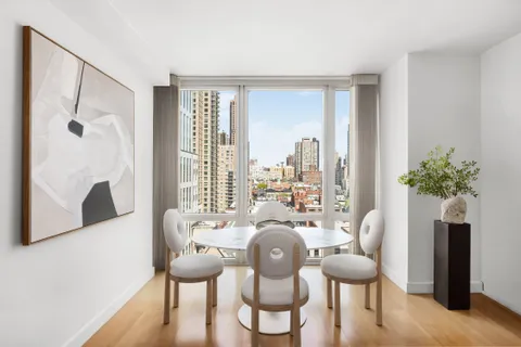 a dining room with furniture window and wooden floor