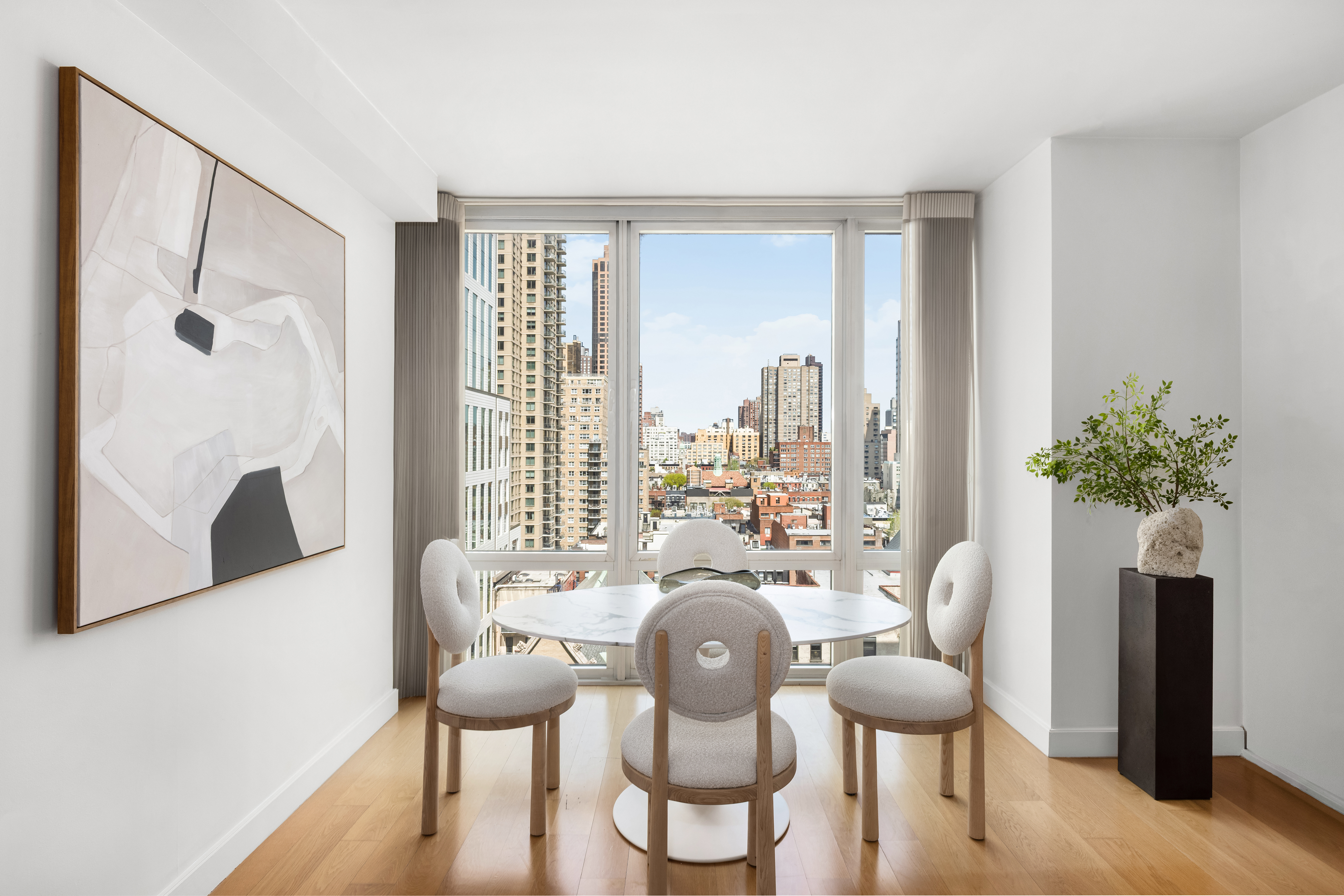 408 East 79th Street, Unit 14B Manhattan, NY 10075 - Photo 3 of 18 a dining room with furniture window and wooden floor