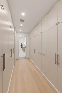 a view of a hallway with wooden cabinet