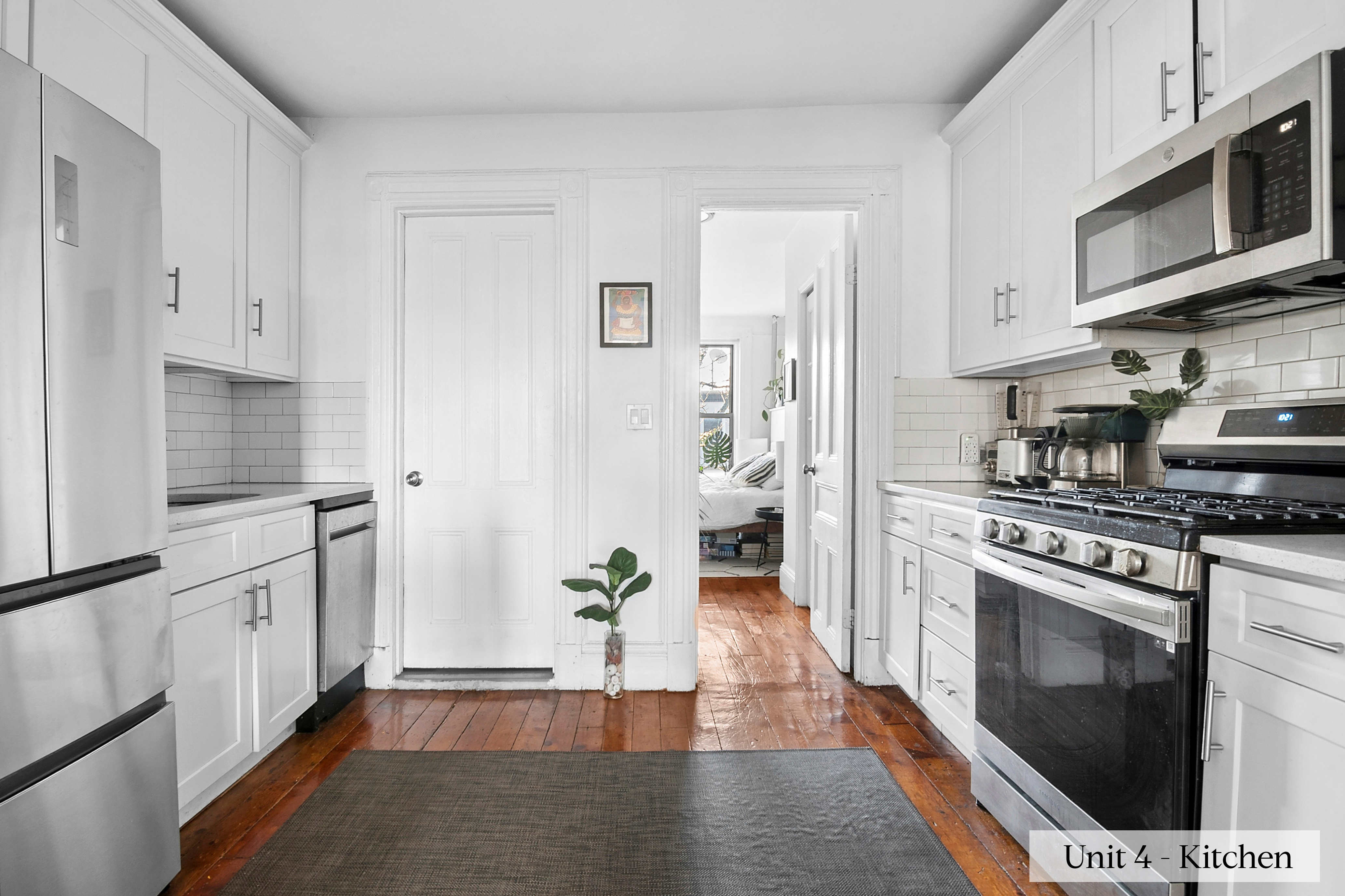 460 9th Street Brooklyn, NY 11215 - Photo 4 of 24 a kitchen with stainless steel appliances a stove a microwave and a refrigerator