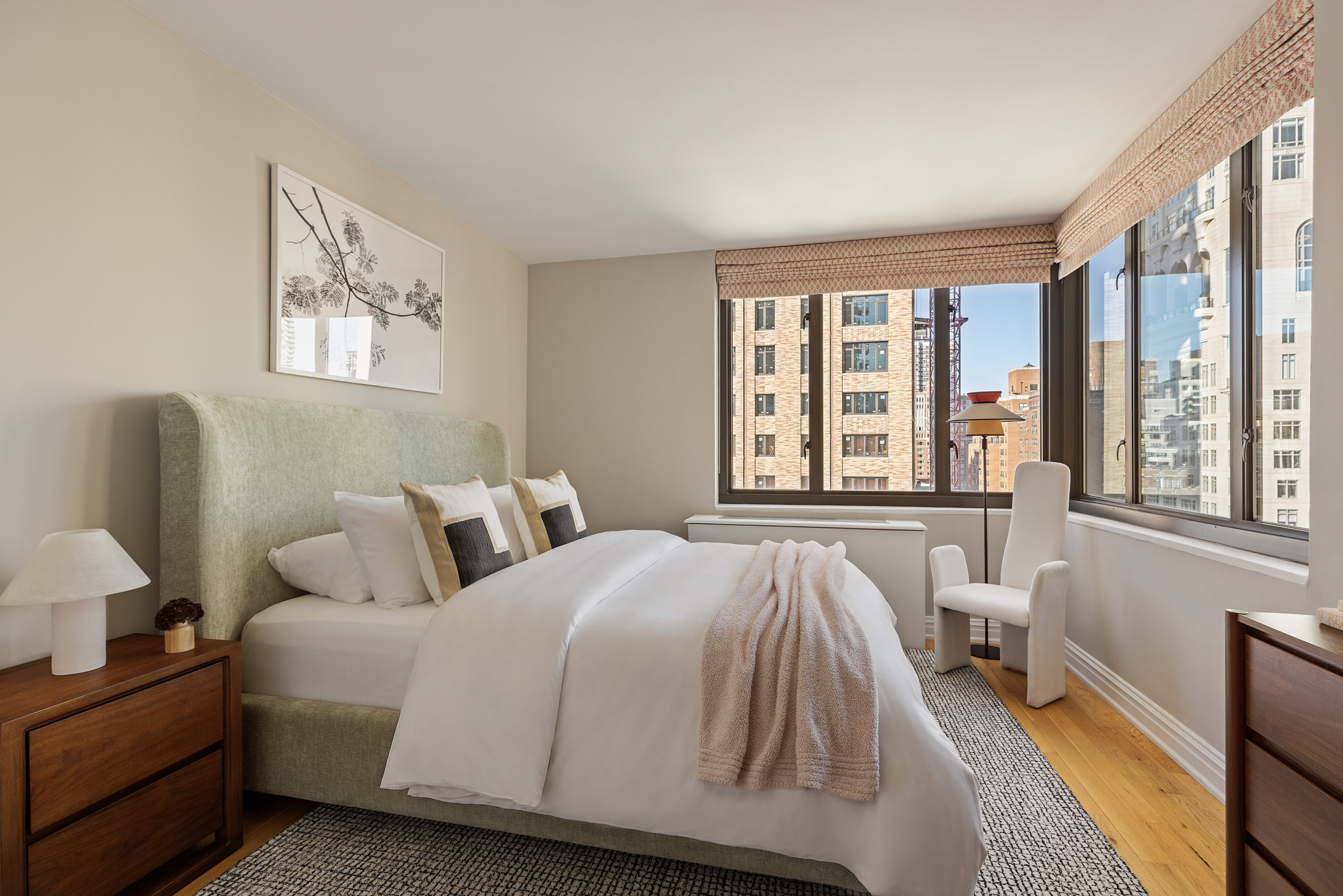1438 3rd Avenue, Unit 15B Manhattan, NY 10028 - Photo 16 of 21 a spacious bedroom with a bed and a large window with outer view