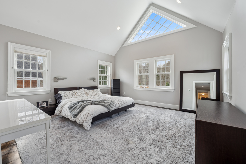 79 Pine Street Dover, MA 02030 - Photo 20 of 25 a spacious bedroom with a bed and a window