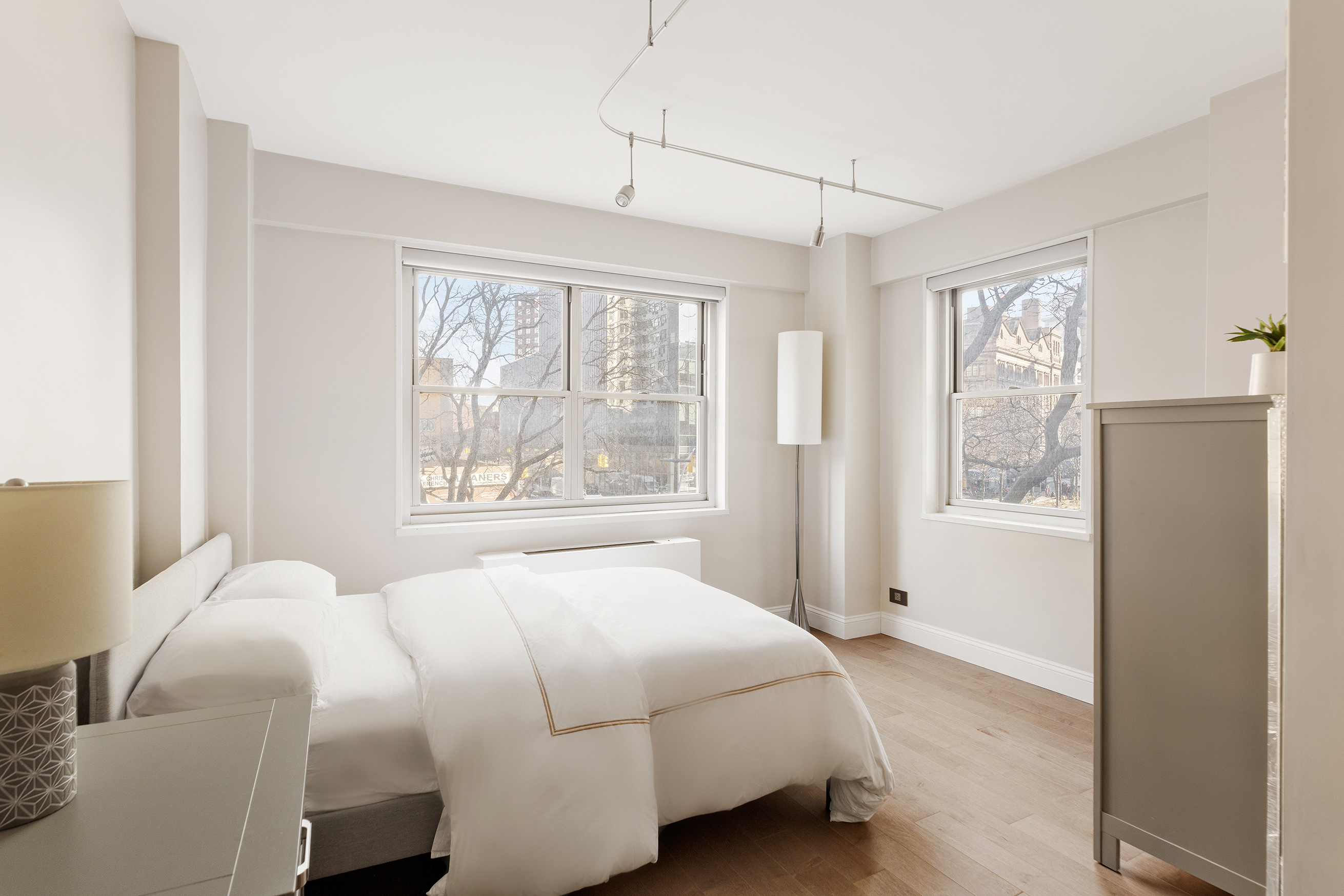 70 East 10th Street, Unit 3B Manhattan, NY 10003 - Photo 7 of 11 a bedroom with a bed and a large window
