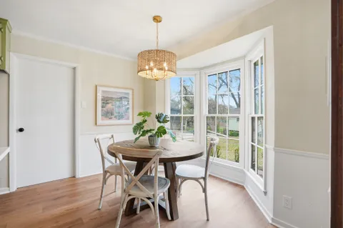 a view of a dining room with furniture wooden floor and chandelier
