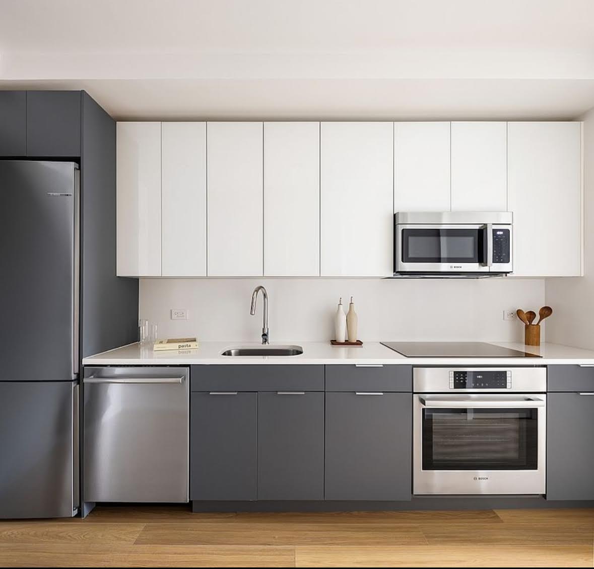5 South 5th Street, Unit 308 Brooklyn, NY 11249 - Photo 3 of 13 a kitchen with stainless steel appliances granite countertop a sink a stove a microwave and a refrigerator