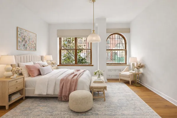 a spacious bedroom with a bed and glass windows