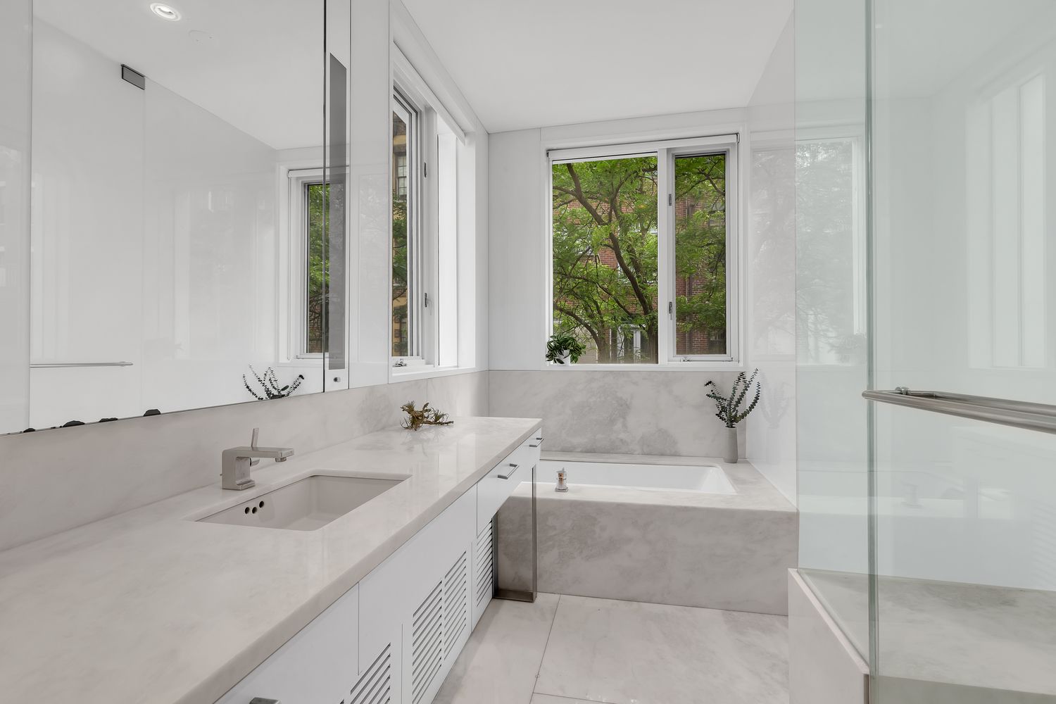 42 West 71st Street Manhattan, NY 10023 - Photo 16 of 35 a bathroom with a tub sink and mirror