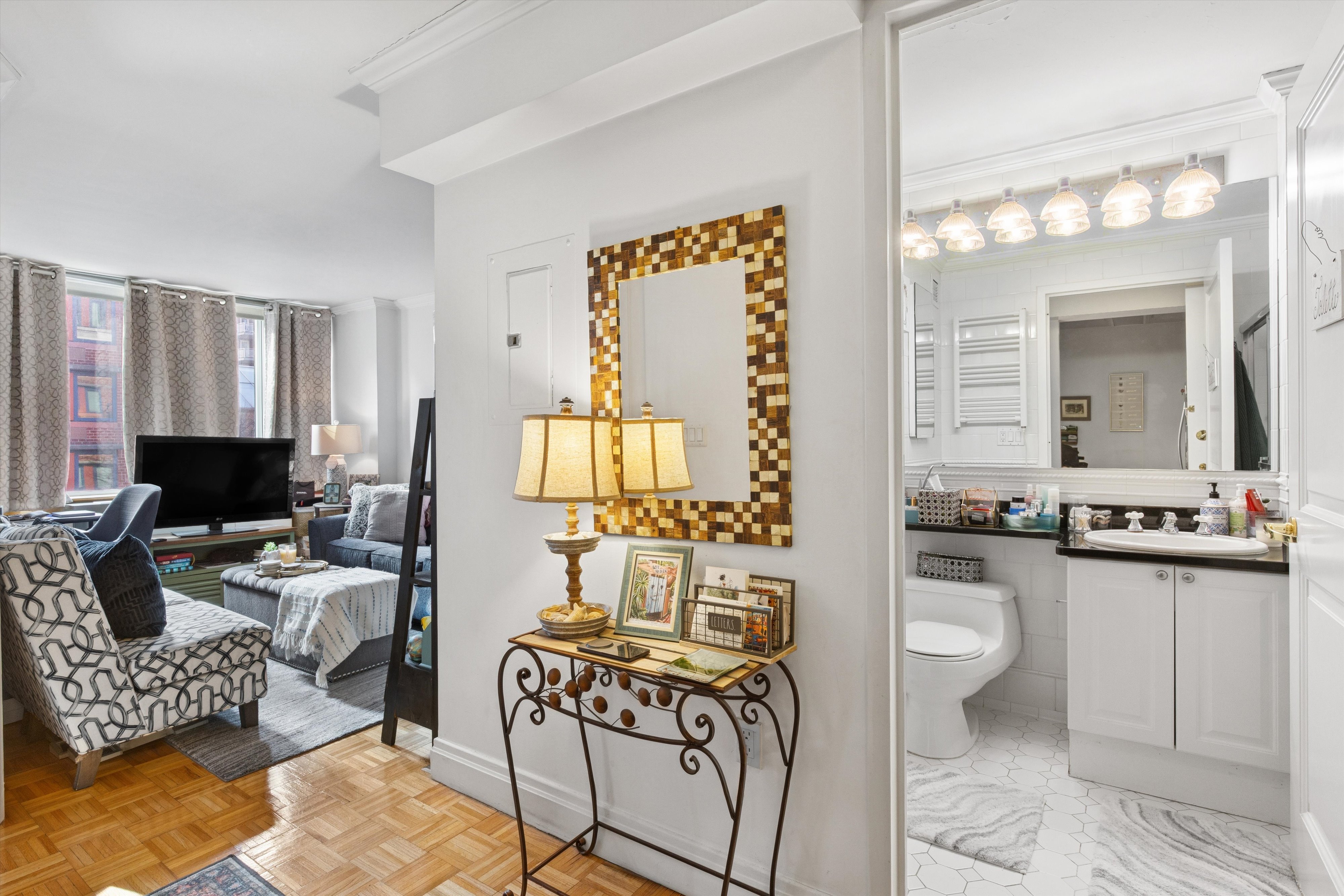 404 East 76th Street, Unit 4M Manhattan, NY 10021 - Photo 6 of 13 a living room with furniture or couch and a flat screen tv