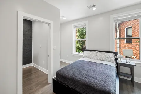 a bedroom with a bed and a window