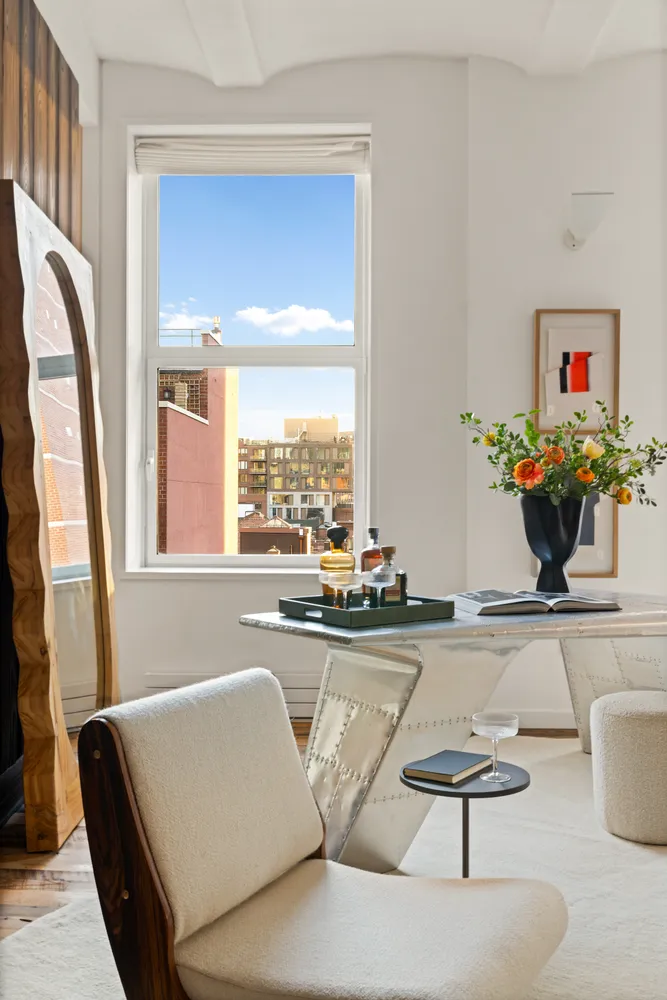 a living room with furniture and floor to ceiling window