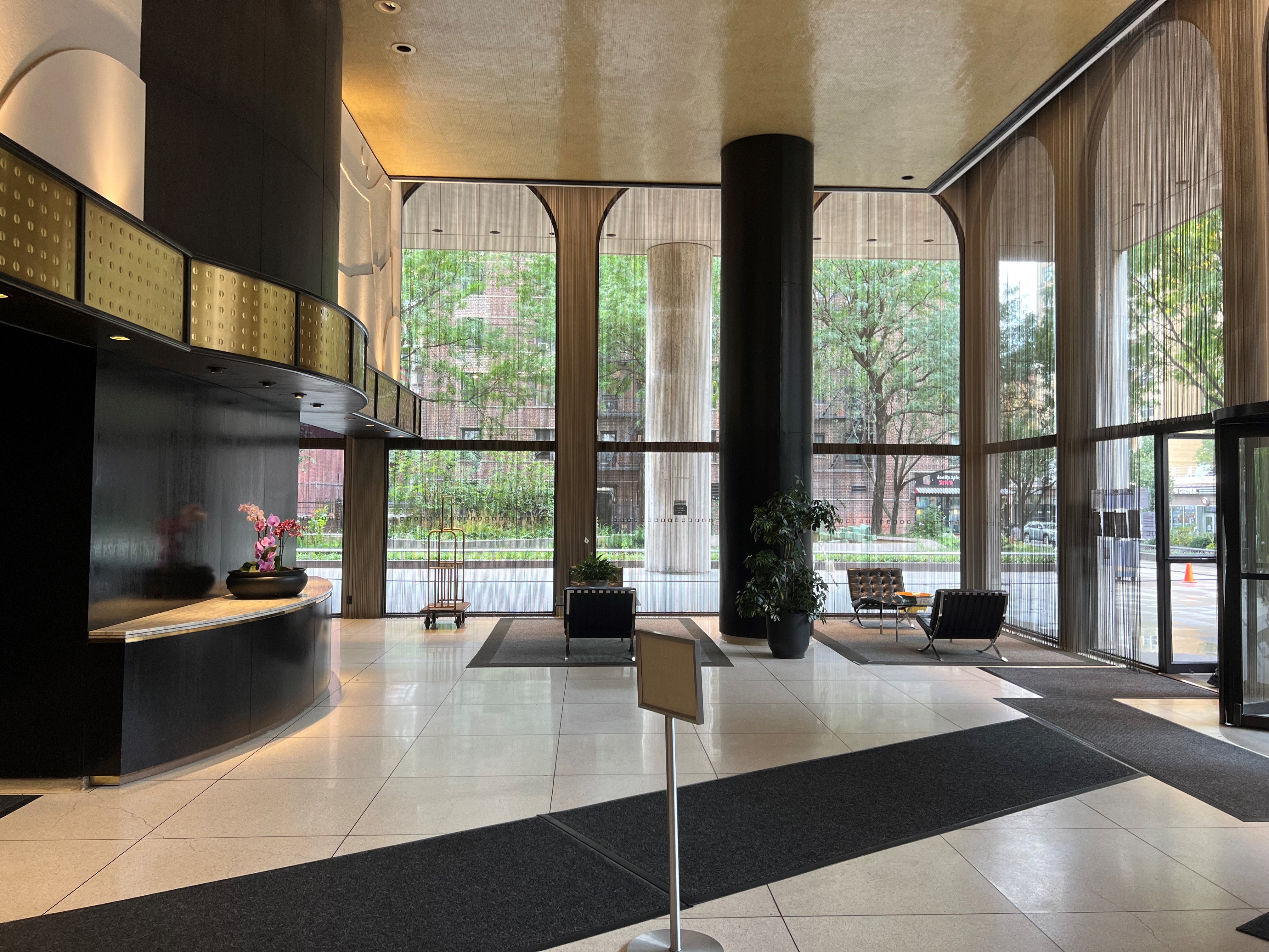 60 East 8th Street, Unit 23D Manhattan, NY 10003 - Photo 14 of 16 a dining room with a large window and table