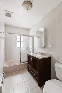 a bathroom with a sink a toilet and mirror