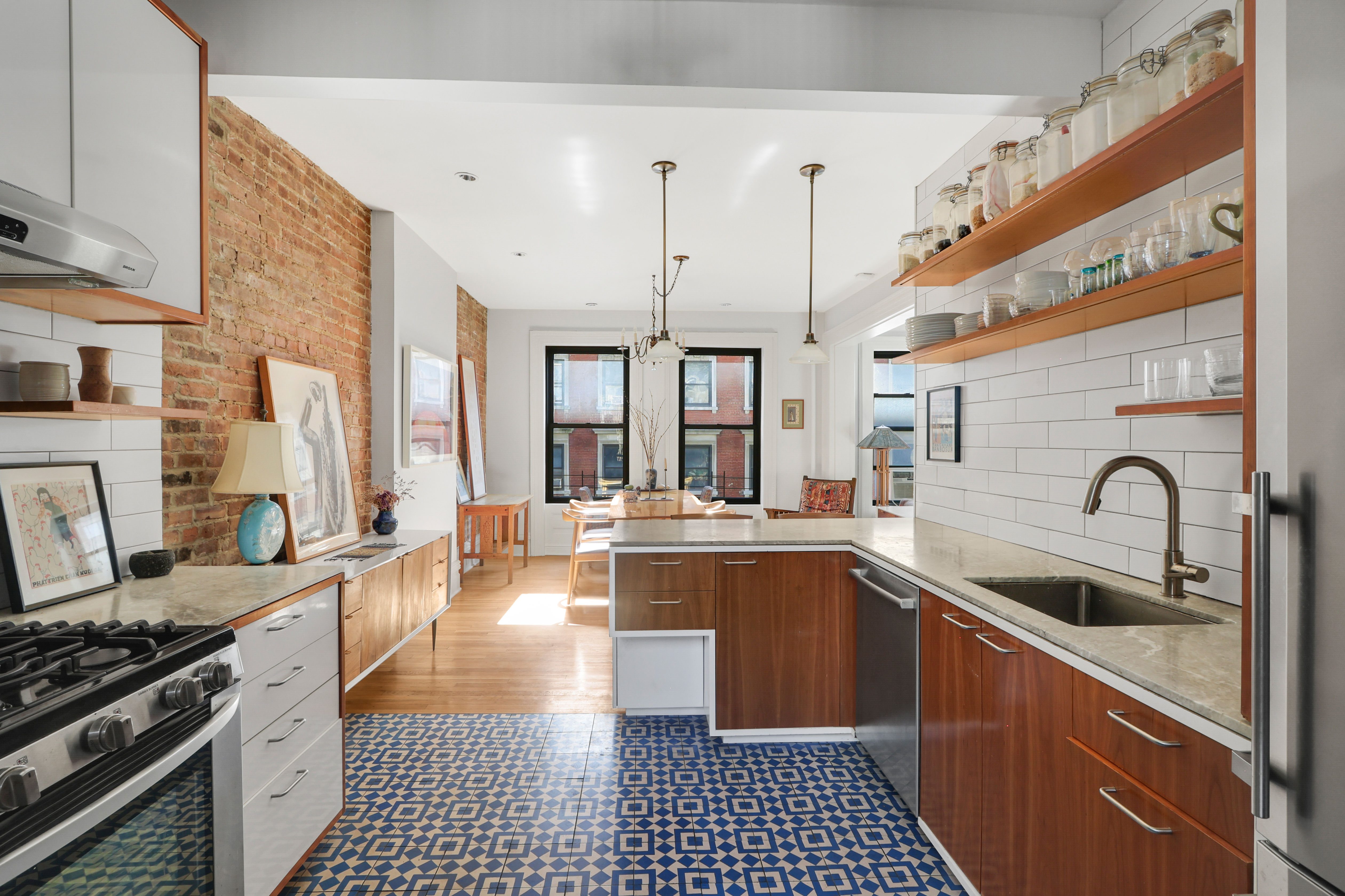 311 West 97th Street, Unit 6E Manhattan, NY 10025 - Photo 9 of 18 a kitchen with stainless steel appliances a sink stove and cabinets