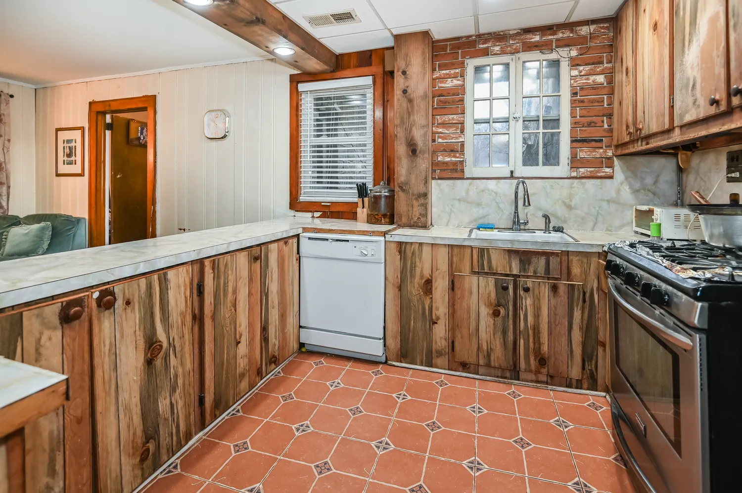 a kitchen with stainless steel appliances a sink stove and cabinets