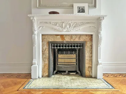 a view of a hallway with wooden floor and a window