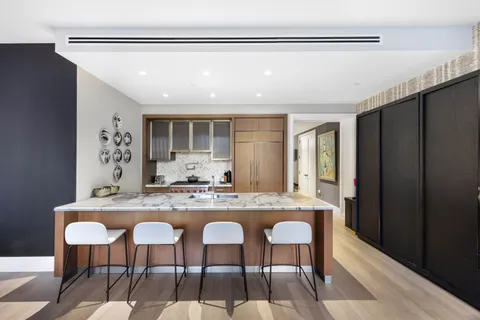 a large kitchen with kitchen island a sink stove and refrigerator