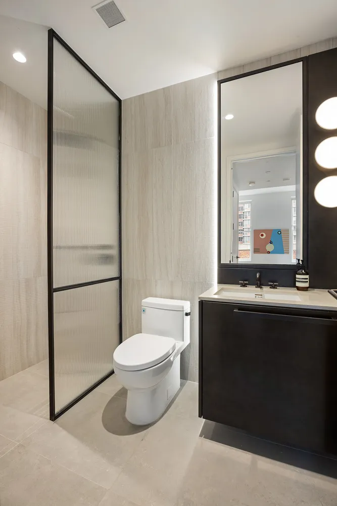 a bathroom with a sink toilet and shower