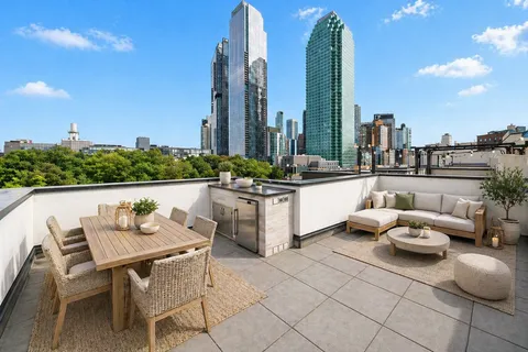 a outdoor living space with furniture and city view