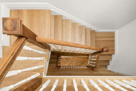 a view of an empty room with stairs and toys