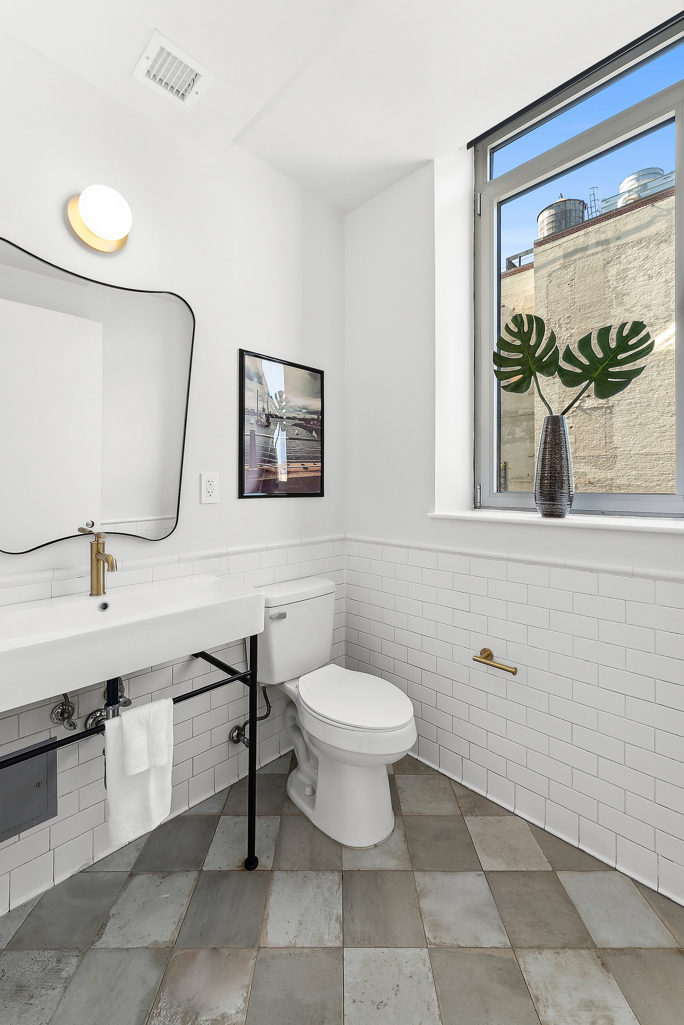 224 West 18th Street, Unit PHA Manhattan, NY 10011 - Photo 17 of 24 a bathroom with a toilet sink and mirror