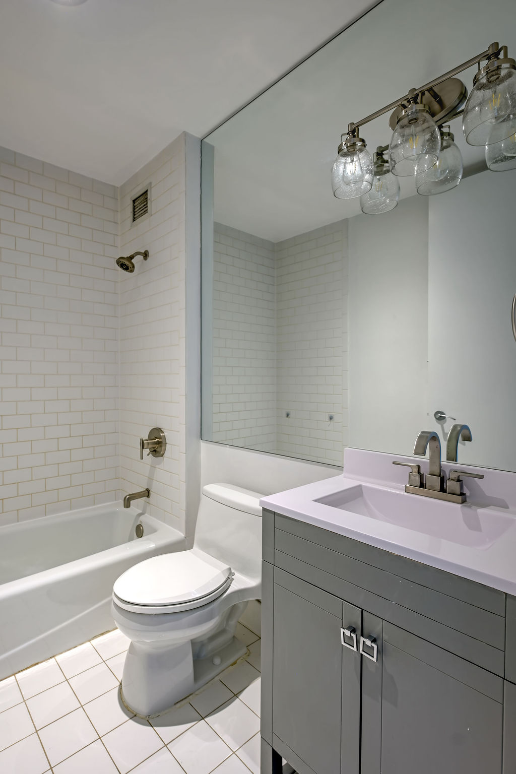 32 West 128th Street, Unit 4 Manhattan, NY 10027 - Photo 7 of 12 a bathroom with a sink a toilet and shower