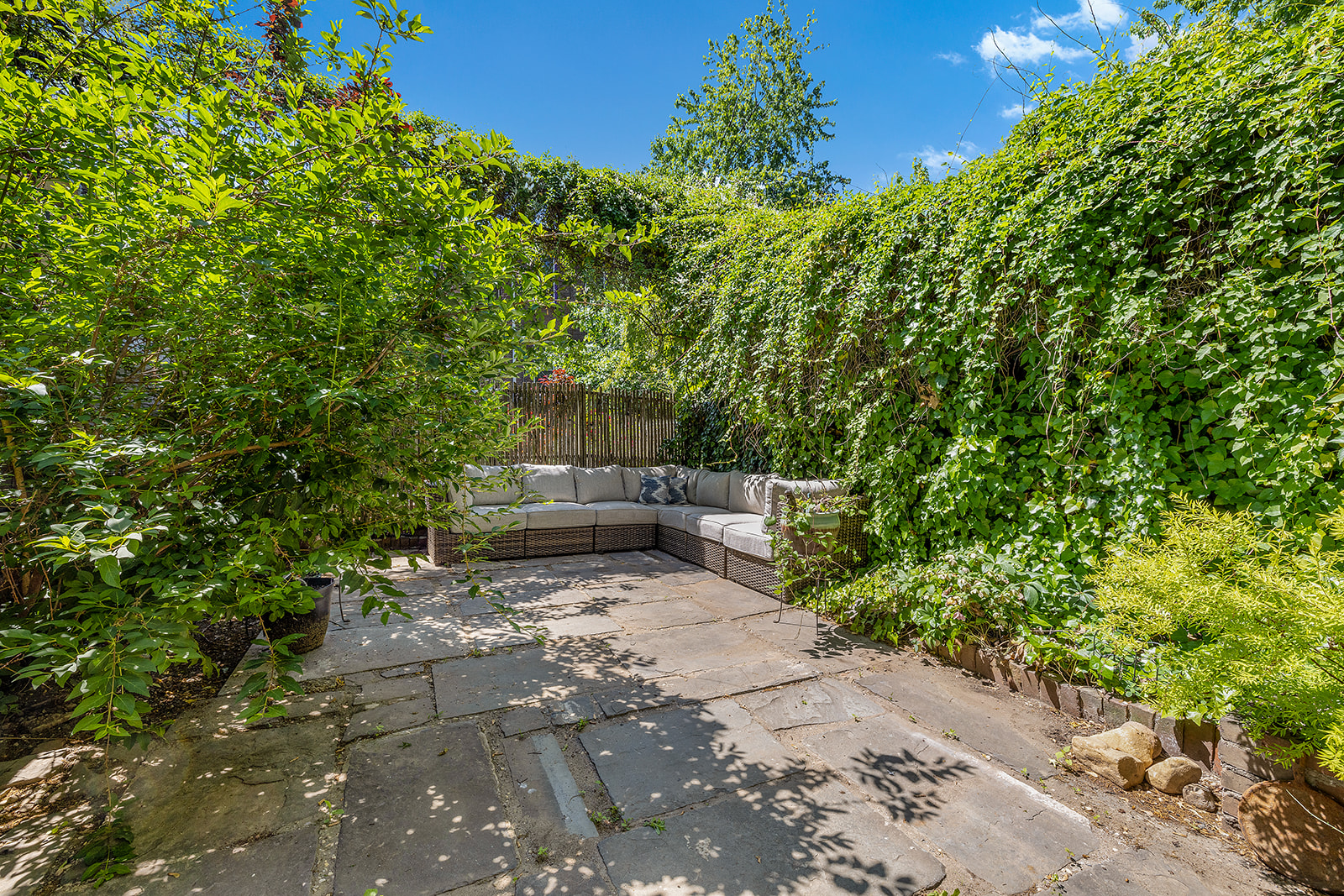 a view of backyard with outdoor seating and green space