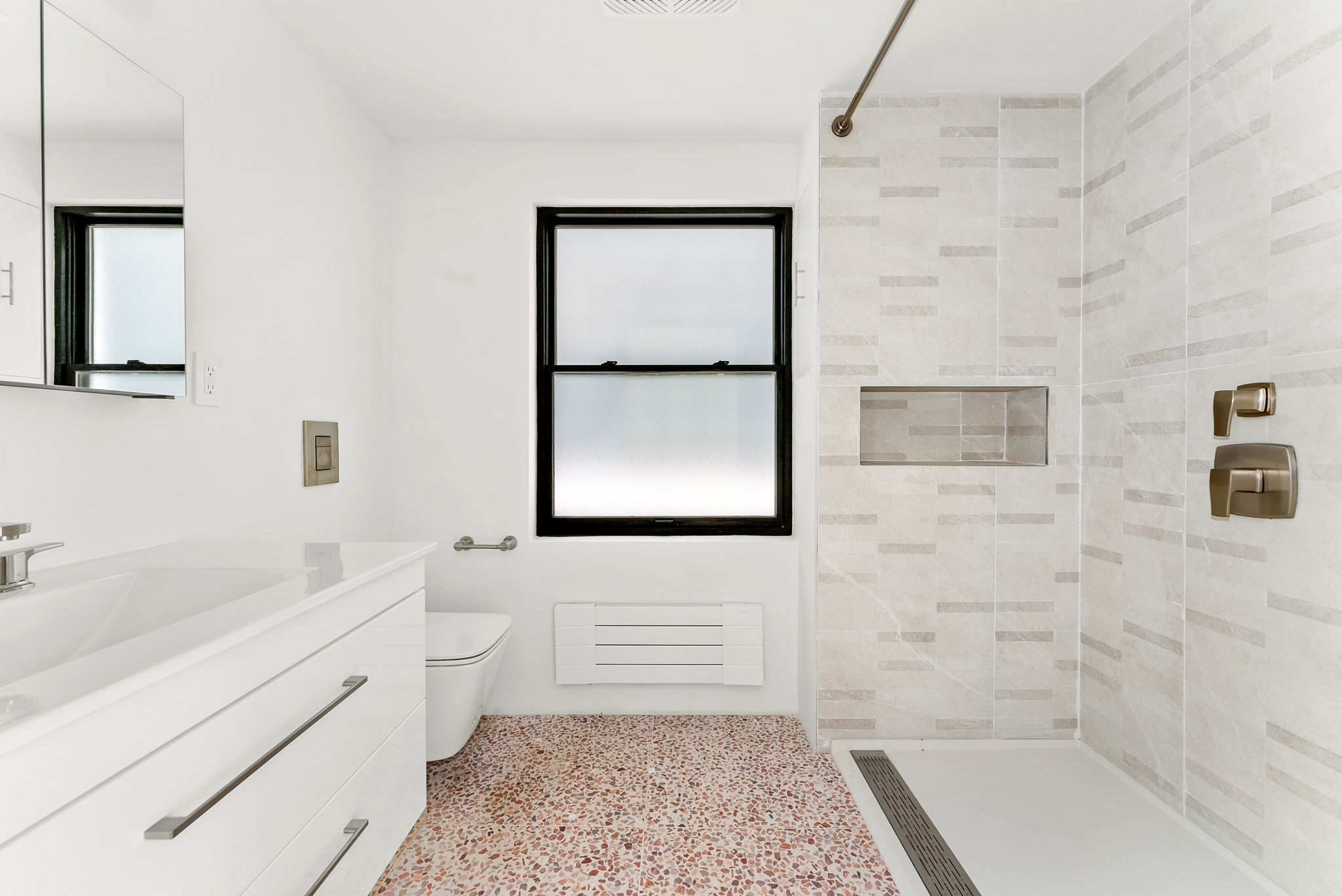 54 East 4th Street, Unit 1 Brooklyn, NY 11218 - Photo 7 of 12 a bathroom with a sink a bathtub and a shower