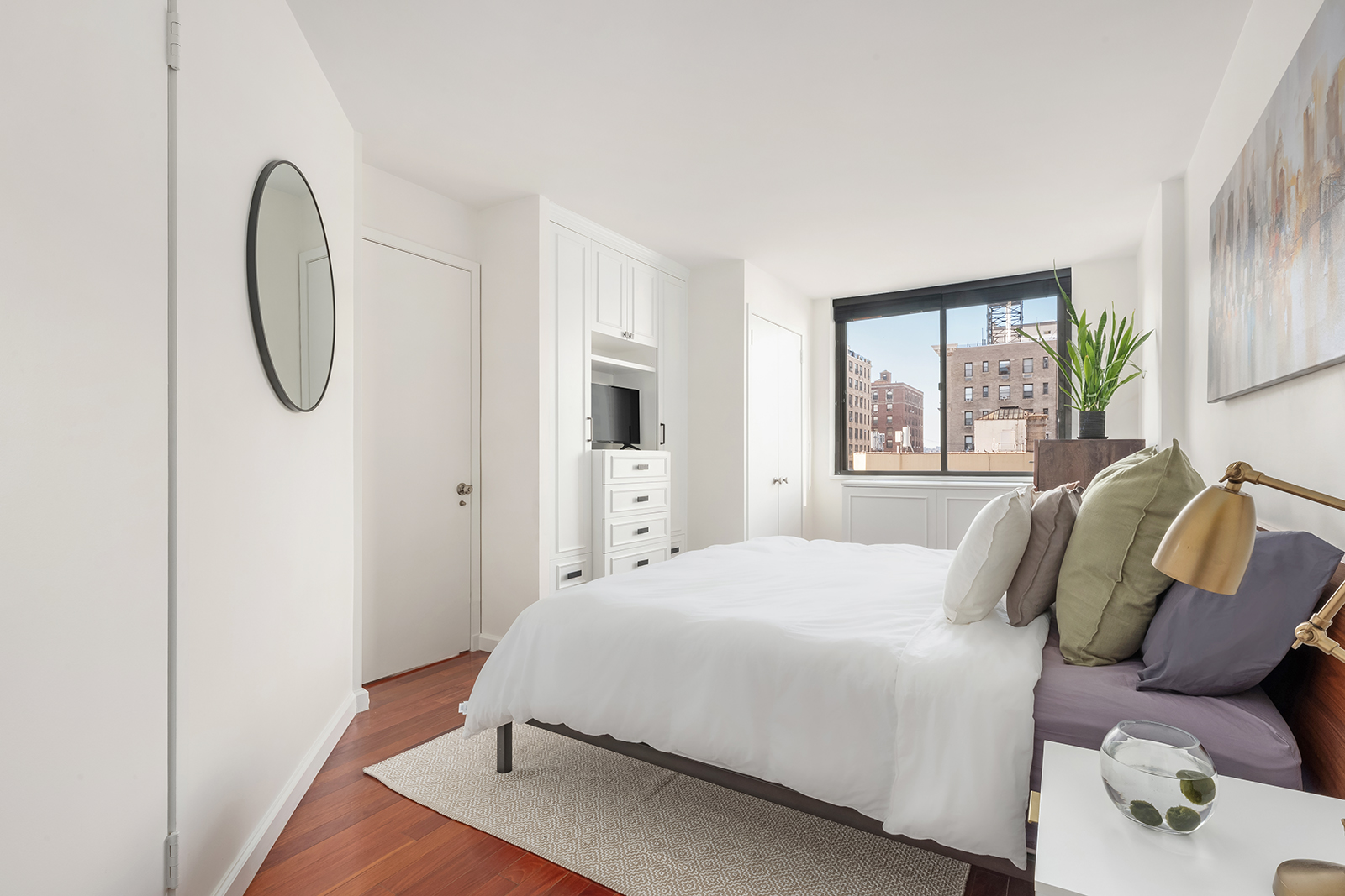 225 West 83rd Street, Unit 8L Manhattan, NY 10024 - Photo 7 of 18 a bedroom with a bed a mirror and windows