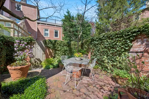 a view of a patio with table and chairs and potted plants