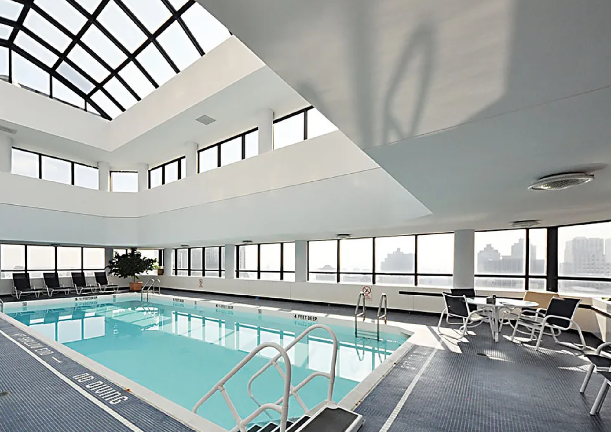 240 East 47th Street, Unit 4B Manhattan, NY 10017 - Photo 18 of 25 a view of a swimming pool with seating space