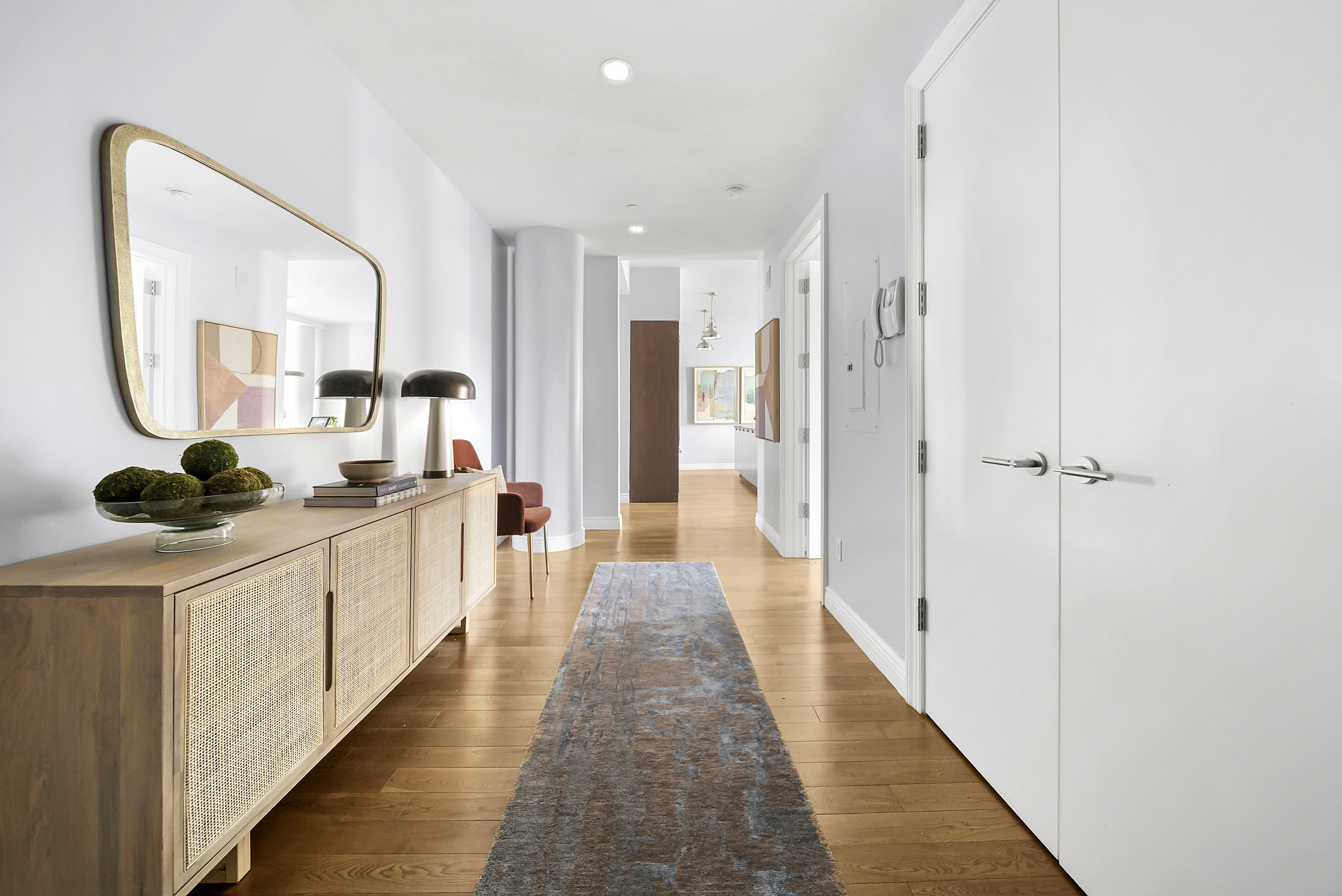 225 5th Avenue, Unit 7K Manhattan, NY 10010 - Photo 6 of 15 a hallway with white doors wooden floor and glass door