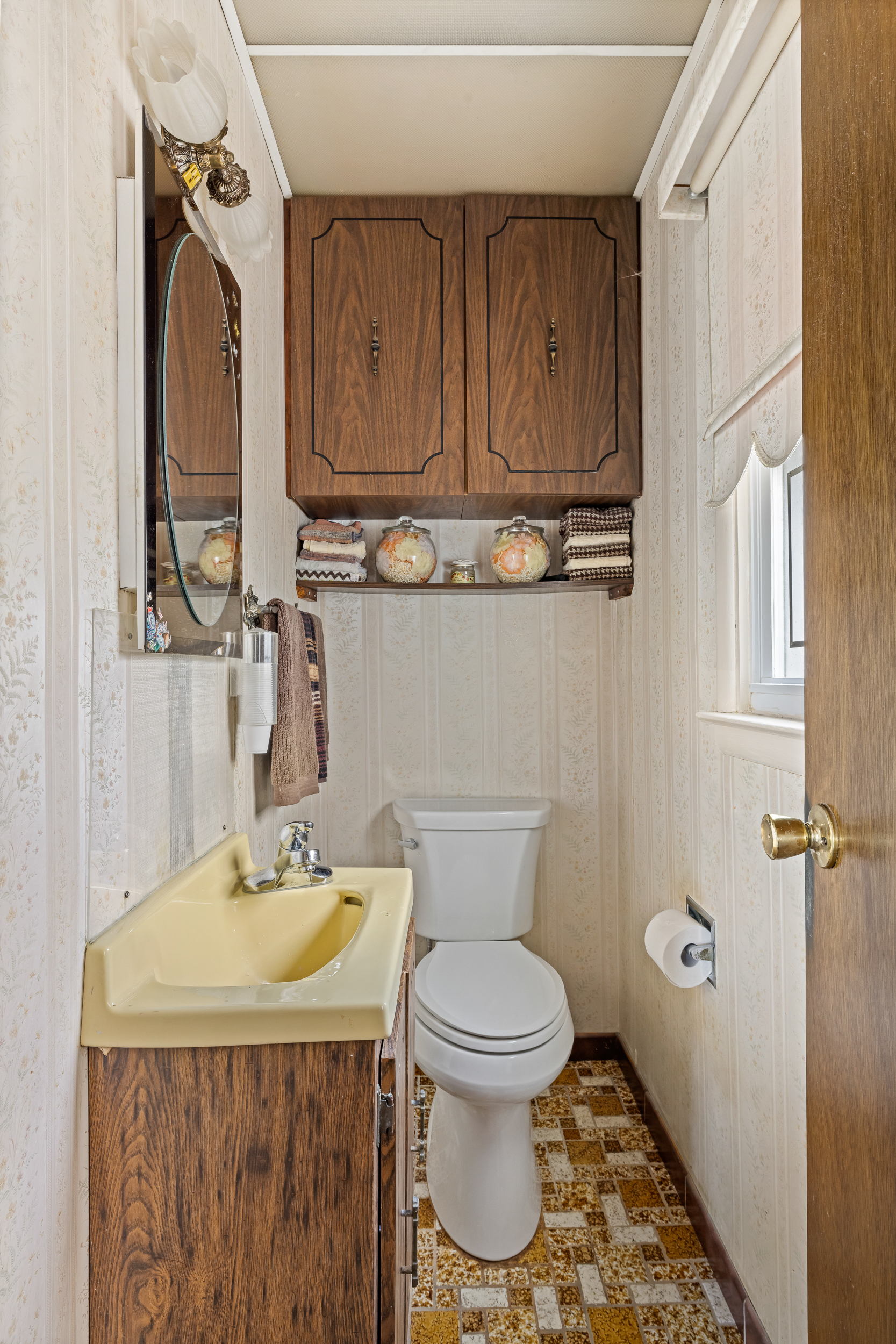 14-28 140th Street Queens, NY 11357 - Photo 11 of 14 a bathroom with a sink a toilet and mirror