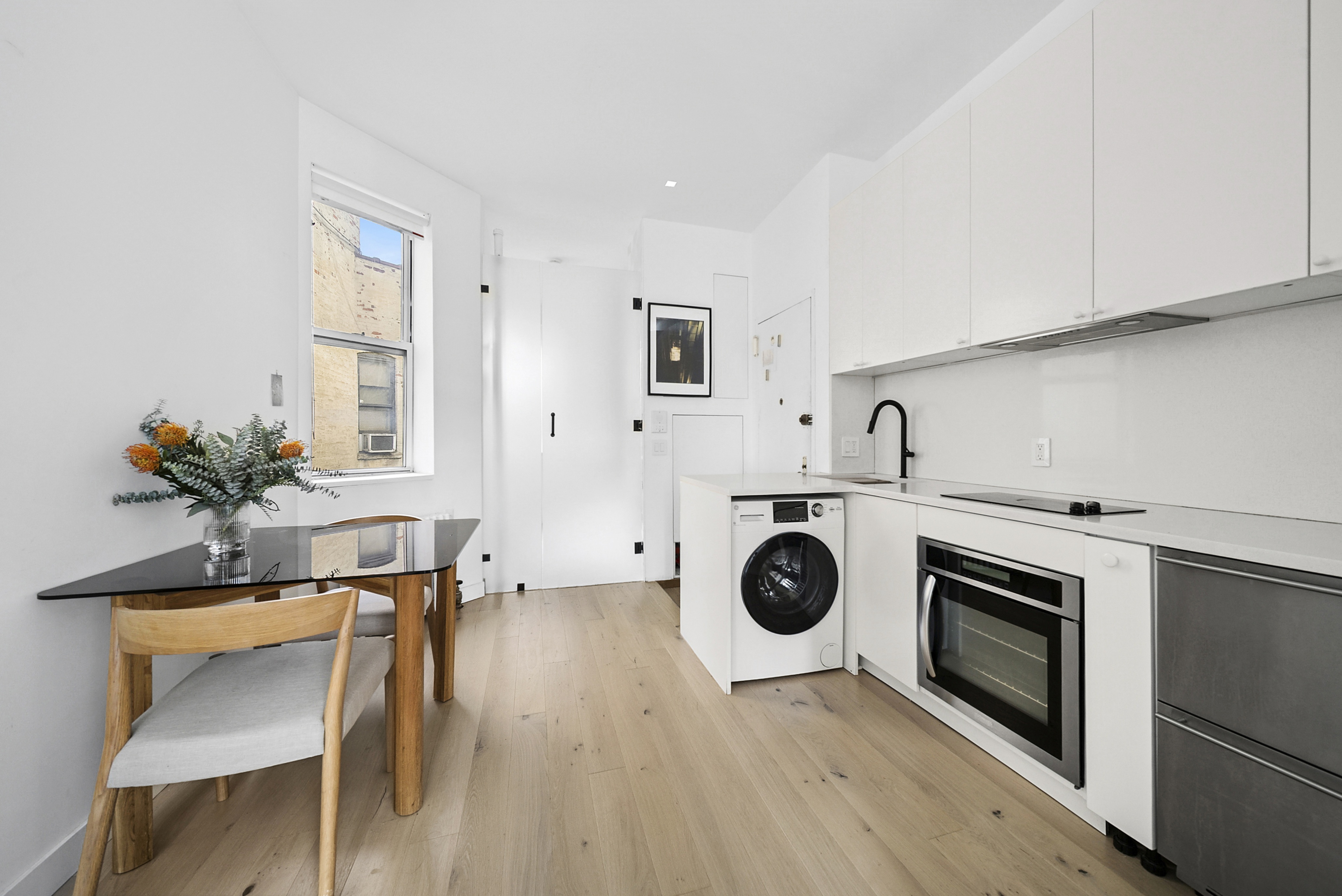 a kitchen with a stove a microwave and cabinets