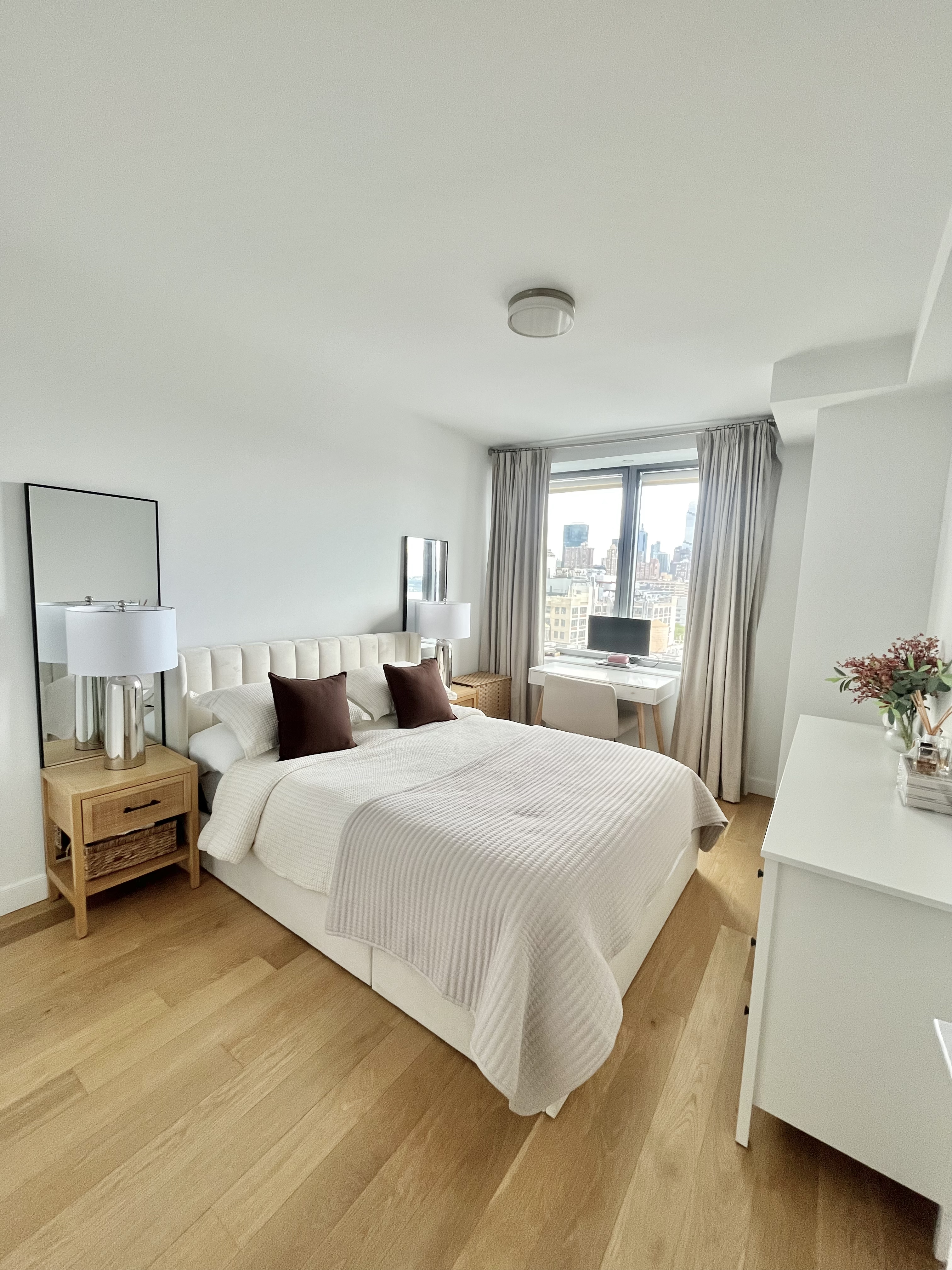 606 West 57th Street, Unit 1612 Manhattan, NY 10019 - Photo 4 of 18 a bedroom with a bed and a large window