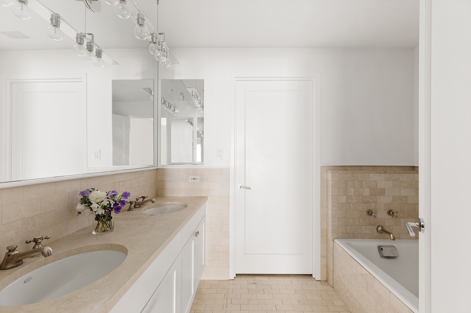 18 Leonard Street, Unit 2D Manhattan, NY 10013 - Photo 15 of 22 a bathroom with a tub sink double vanity and mirror